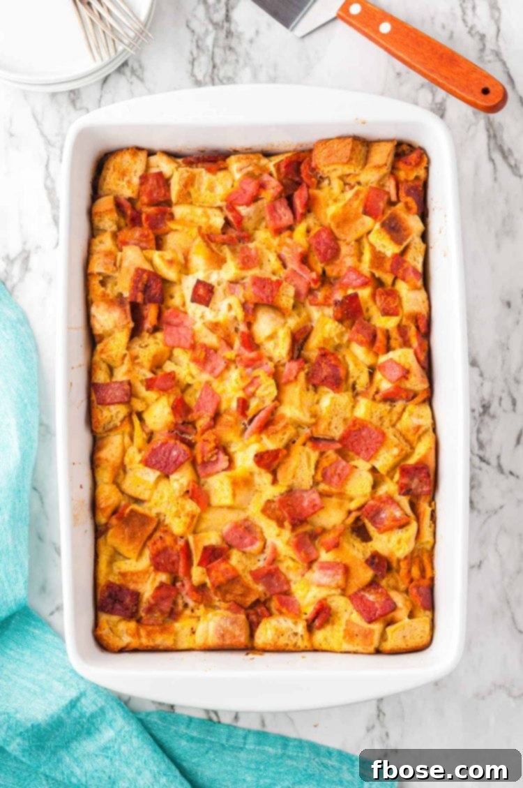 An overhead shot of the baked Eggs Benedict Casserole, showcasing its golden crust and delicious layers.