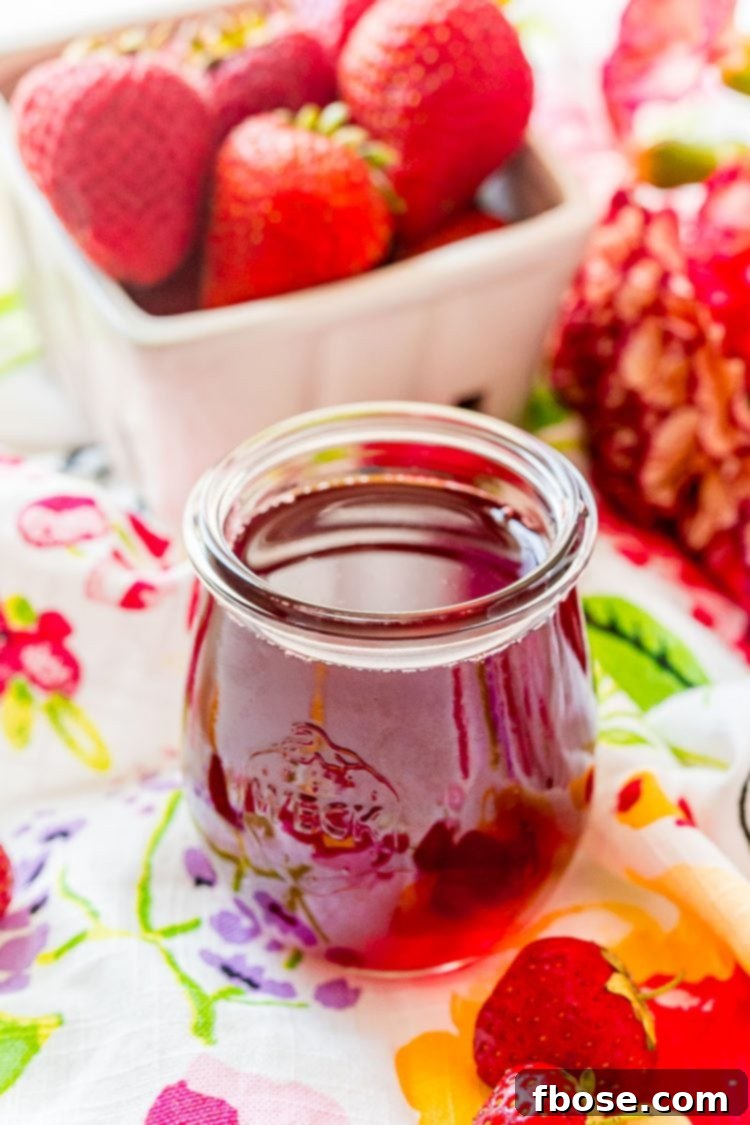 Strawberry simple syrup neatly stored in a small, elegant weck jar, ready for use.