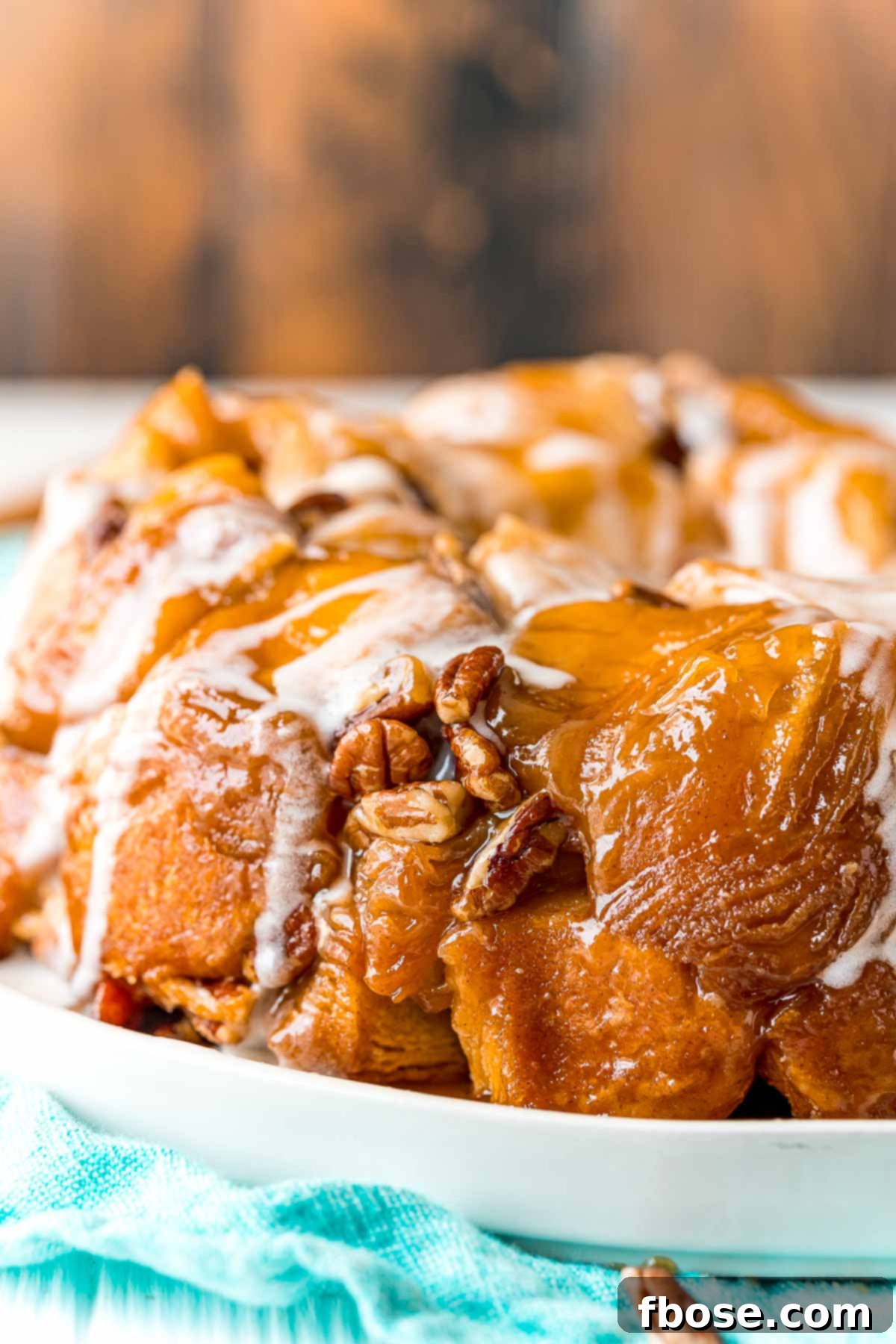 Close up photo of monkey bread on a white plate.