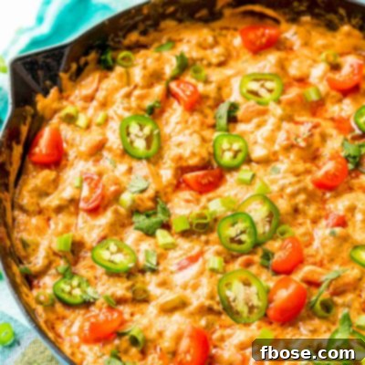 Cheesey sausage dip in a cast iron pan.