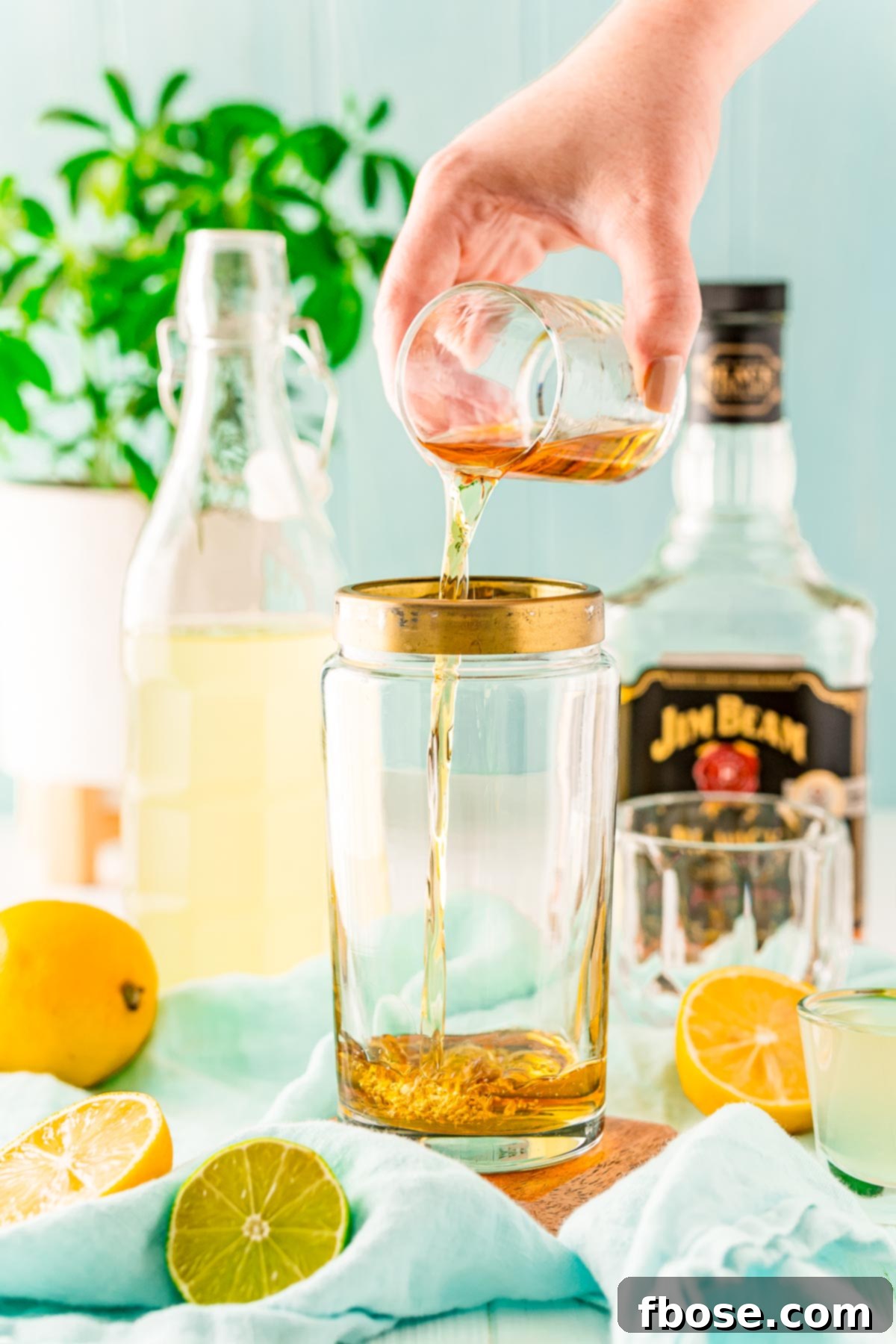 Crafting the Perfect Bourbon Sour 4 Bourbon being added to a cocktail shaker.