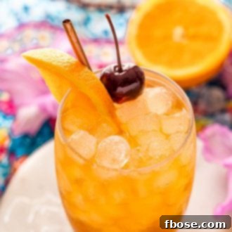 Close up angled photo of a class with an amaretto sour.