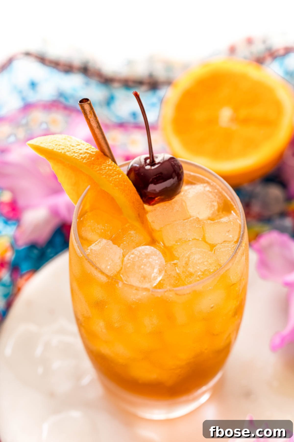 Close up angled photo of a class with an amaretto sour.