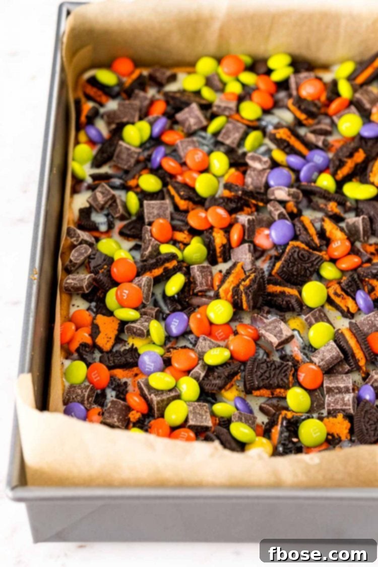 Spellbound Seven-Layer Bars 6 Halloween 7 layer bars being prepped in a baking pan.