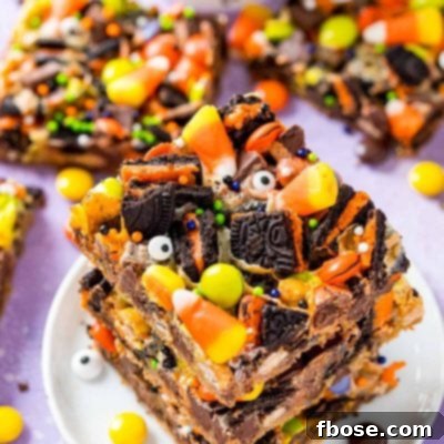 Spellbound Seven-Layer Bars 10 A stack of three halloween magic cookie bars on a small white plate on a purple surface.