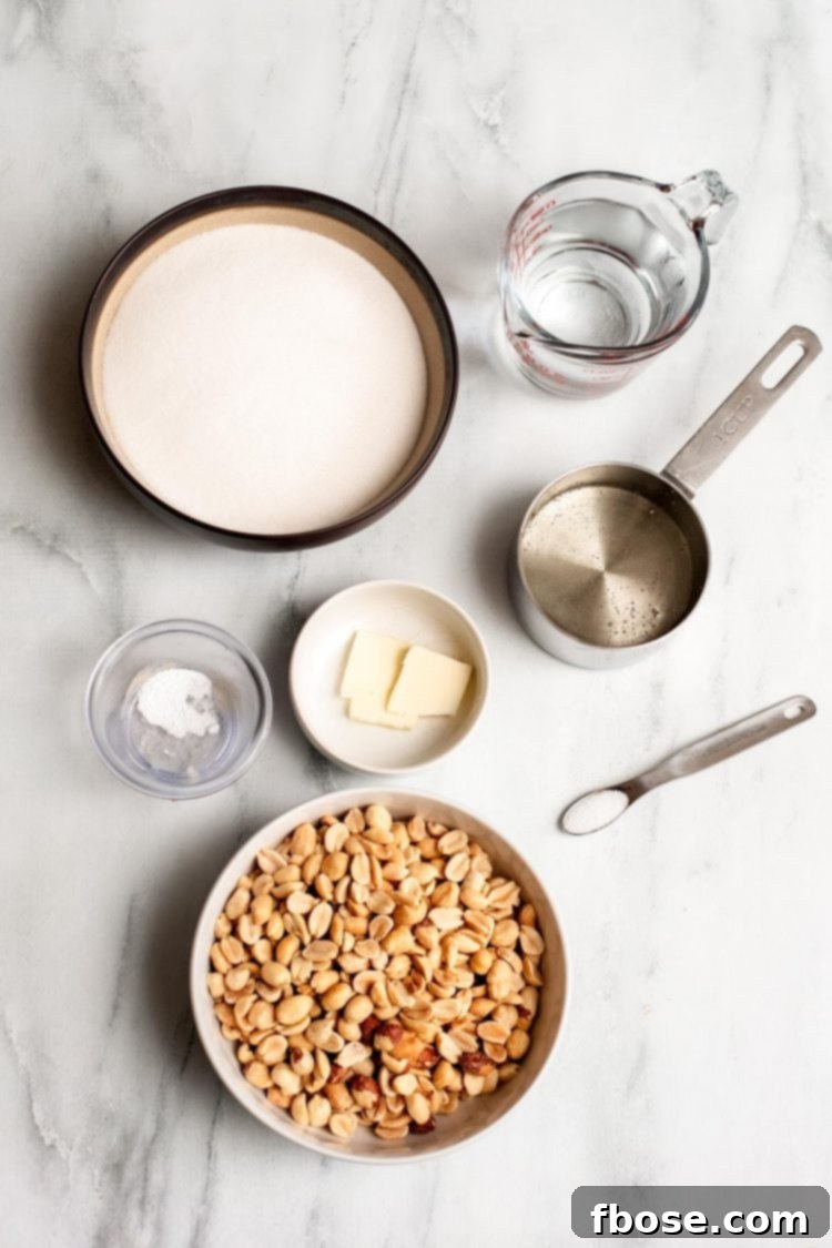 Overhead photo of ingredients to make peanut brittle on a marble surface.