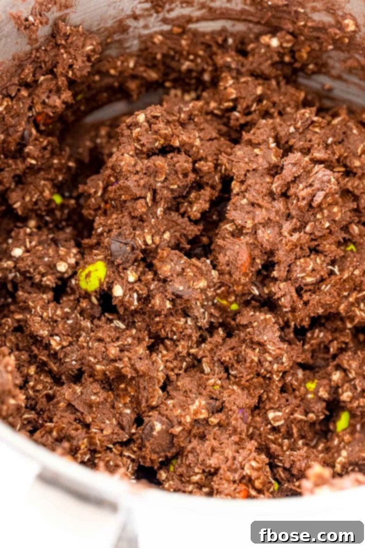 Chocolate oatmeal cookie dough in a mixing bowl.