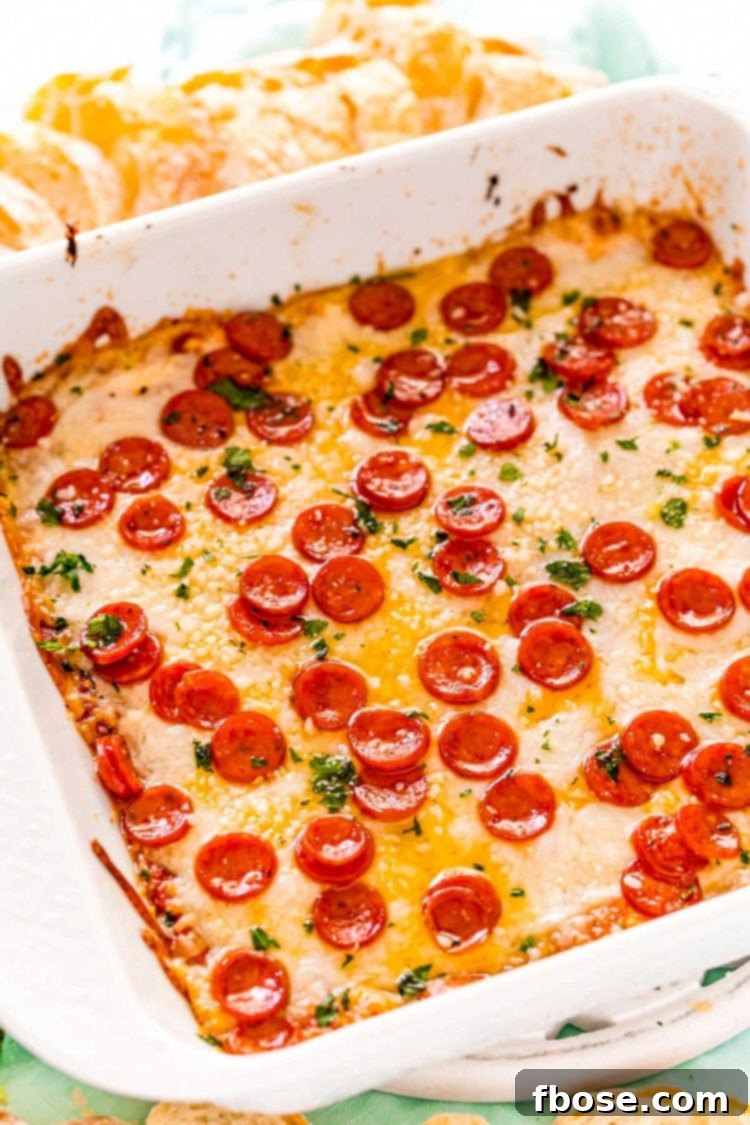 Pizza dip in a white square baking dish.