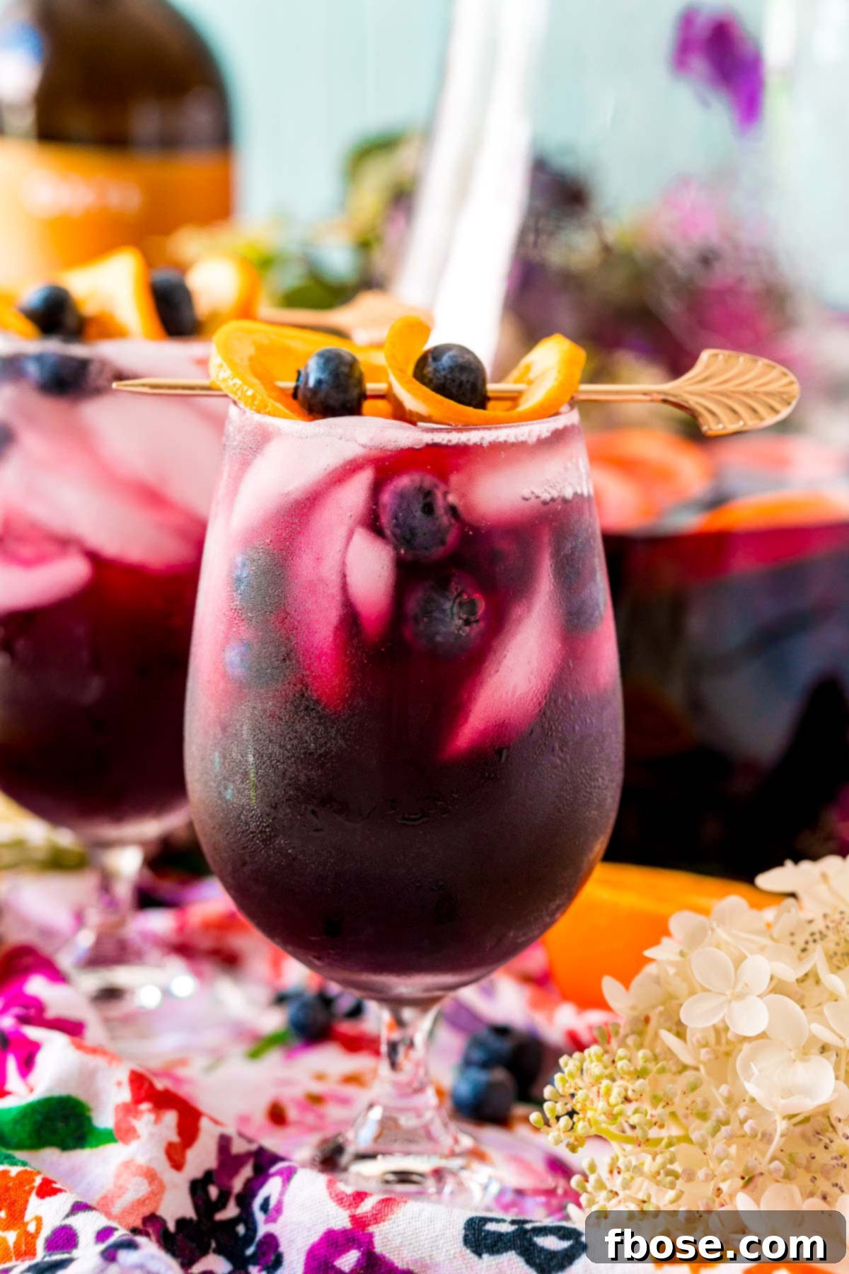 Close up photo of blueberry sangria in wine glasses and in a serving pitcher.