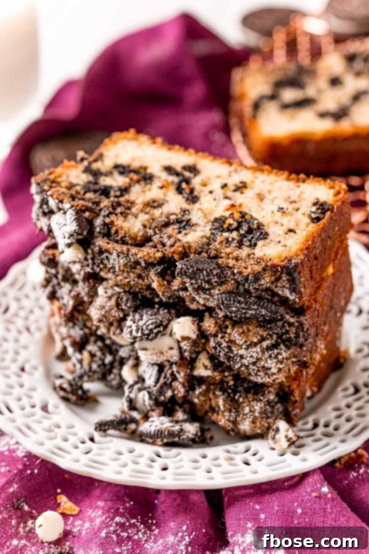 Two generous slices of cookies and cream coffee cake stacked on a white plate, resting on a vibrant purple napkin, ready to be enjoyed.