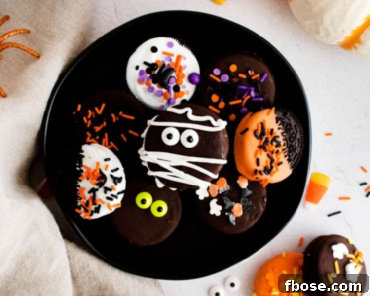 Close up photo of halloween decorate oreos on a black plate.