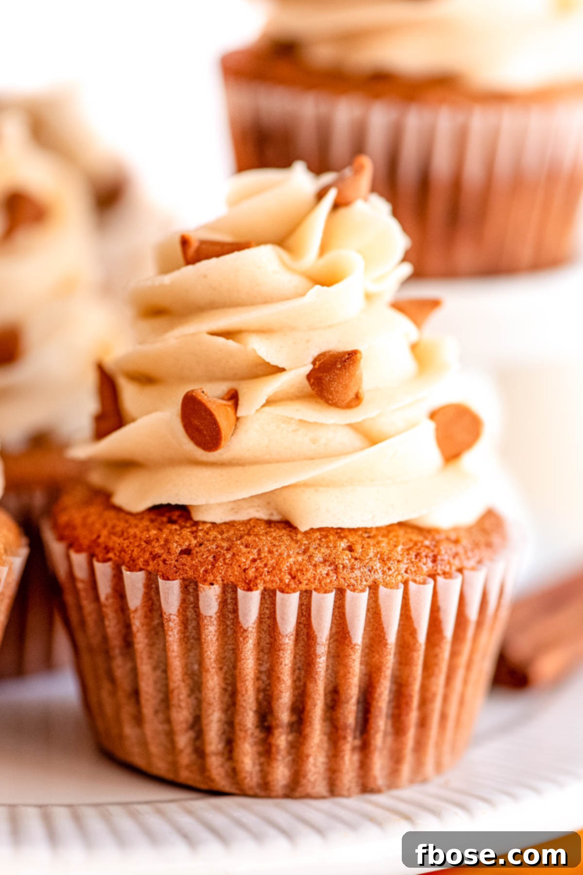 Simple Brown Sugar Delight 9 A beautifully frosted cupcake with brown sugar frosting, elegantly displayed on a white cake stand.