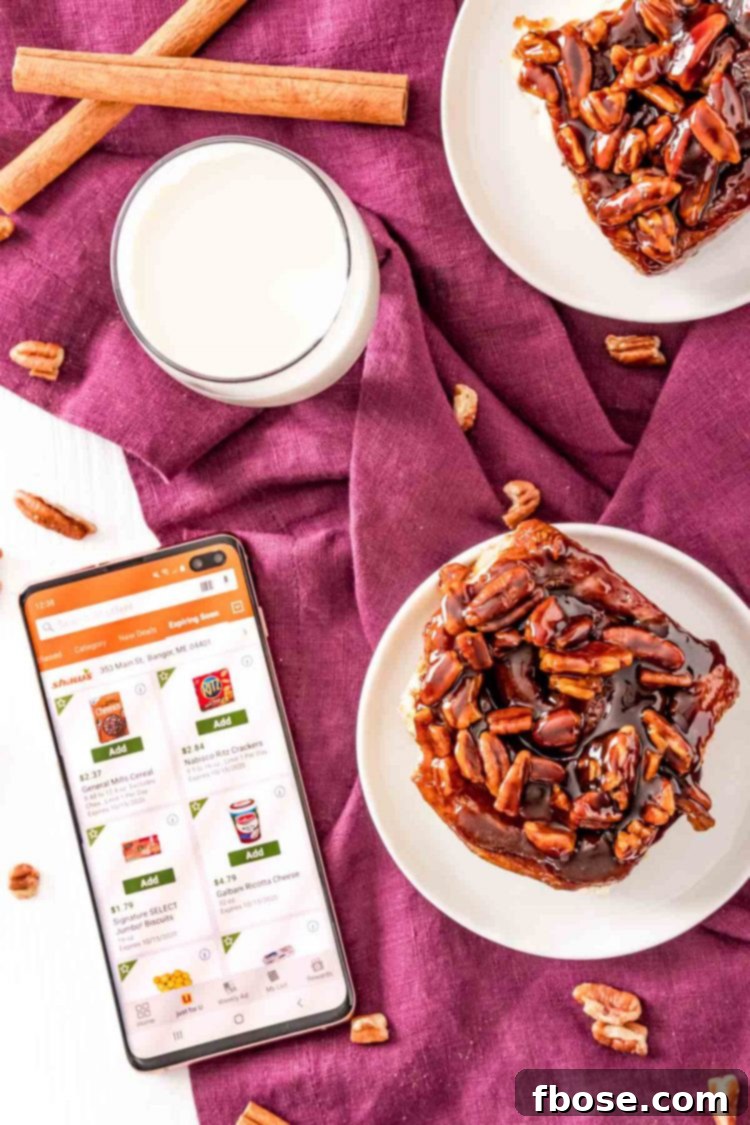 Overhead photo of sticky buns on small white plates with a phone next to them open to the Shaw's app, demonstrating the convenience of shopping.