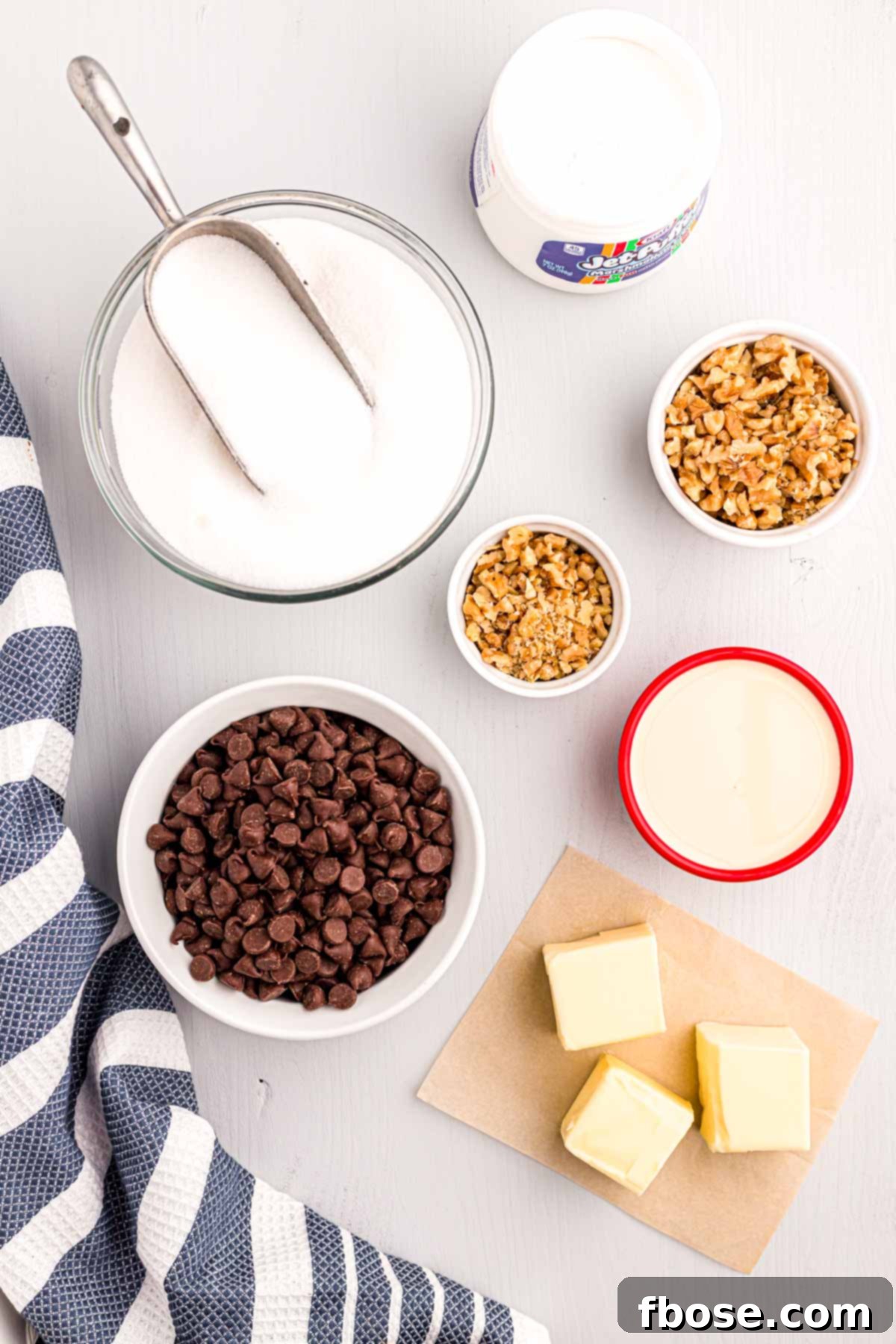 Overhead photo showcasing the simple, essential ingredients needed to create delicious walnut chocolate fudge.