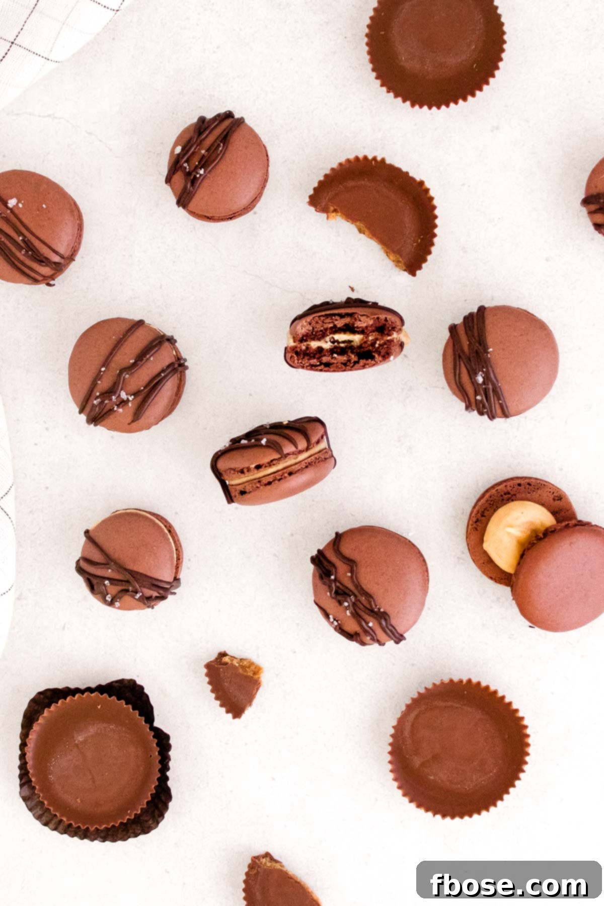 Overhead photo of peanut butter macarons on a white counter.