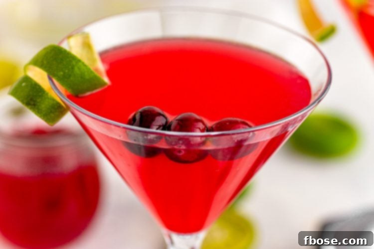 The alluring Cranberry Cosmopolitan, a simple yet sophisticated cocktail featuring a vibrant cranberry kick. Perfect for any gathering, it promises to set the mood for an unforgettable time.