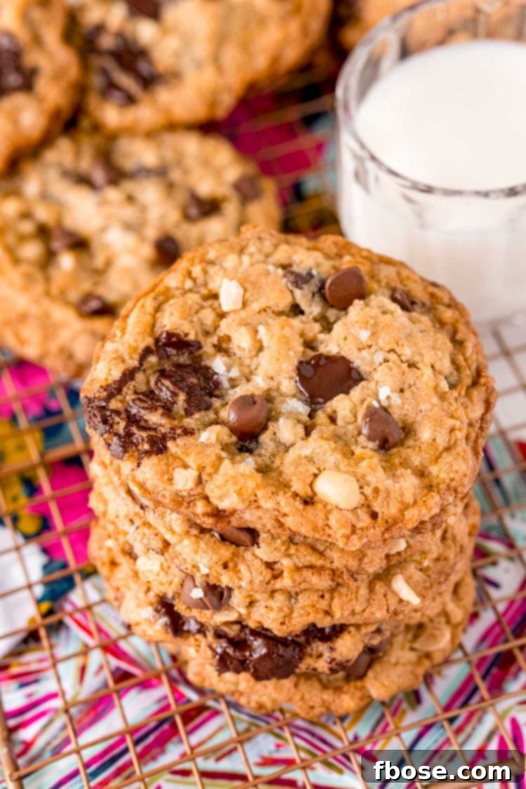 Close up photo of a stack of ranger cookies on a wire rack.