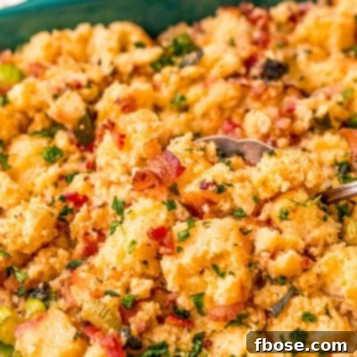 Close up photo of cornbread stuffing getting scooped out of a dish.
