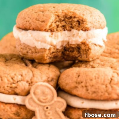 Zencefilli Sandviç Kurabiye, Kahverengi Şeker Kremalı 11 Close up photo of Gingerbread Whoopie pies stacking on eachother on a white plate with a bite taken out of one.