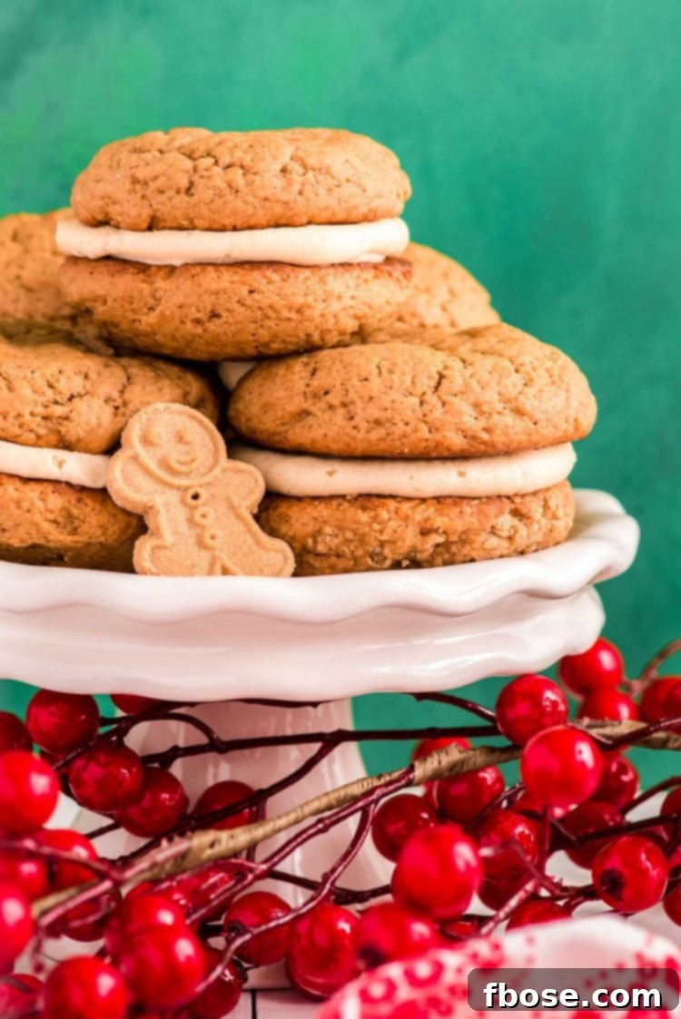 Zencefilli Sandviç Kurabiye, Kahverengi Şeker Kremalı 4 Close up photo of gingerbread flavored whoopie pies on a white cake stand with holly berries around it.