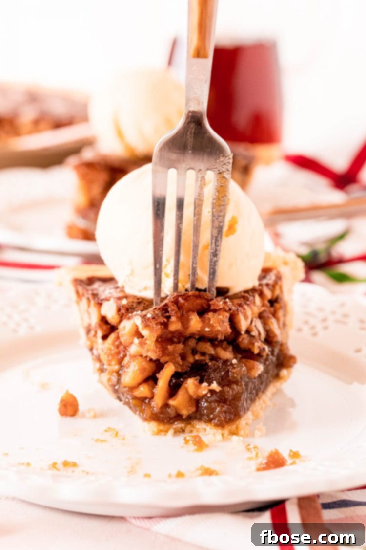A fork piercing into a slice of Maple Walnut Pie, highlighting the rich, gooey filling and the crunchy walnuts within.