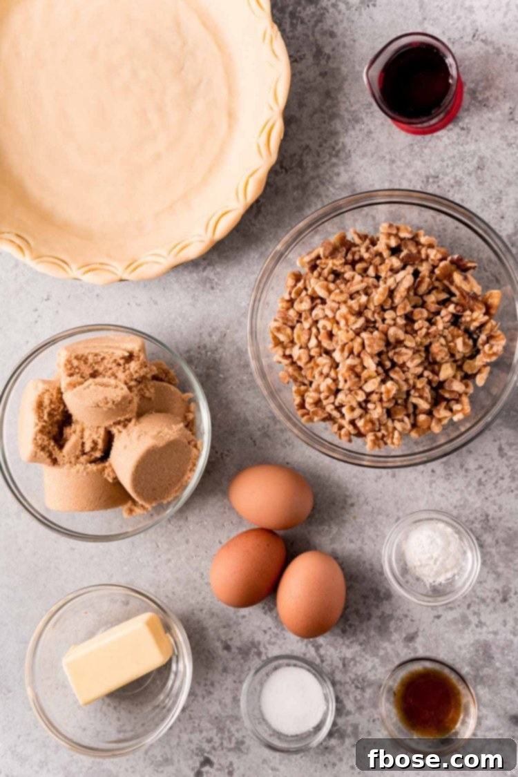 An overhead shot showcasing all the fresh ingredients meticulously arranged on a gray countertop, ready to be transformed into a delicious walnut pie.