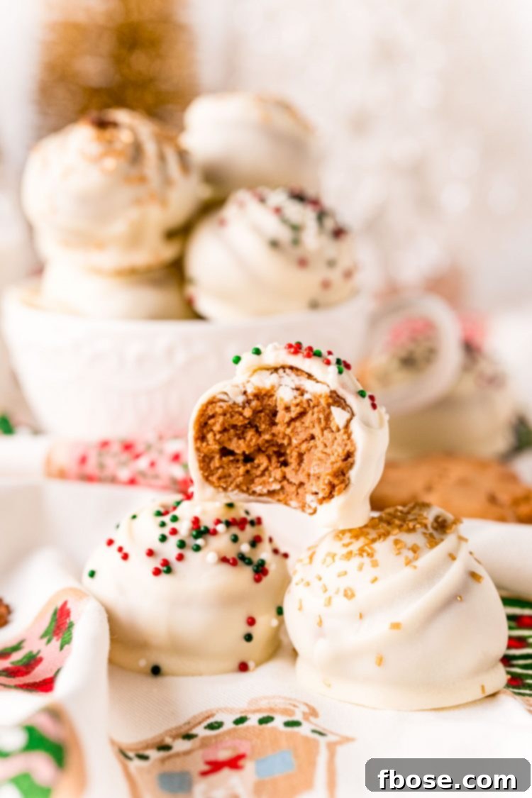 Three perfectly stacked gingerbread balls, with a single bite taken out of the top one, revealing the textured interior.