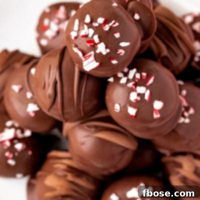 Close up photo of peppermint oreo truffles on a white plate.
