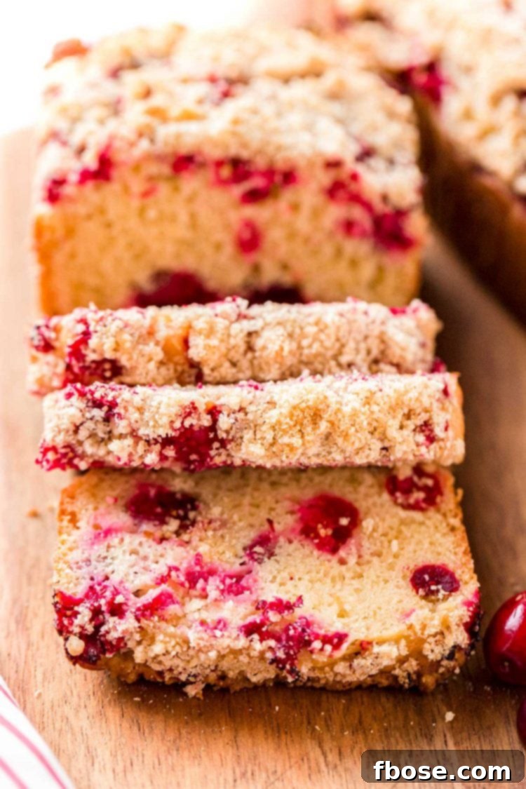 Close up photo of cranberry bread that has been partially sliced.