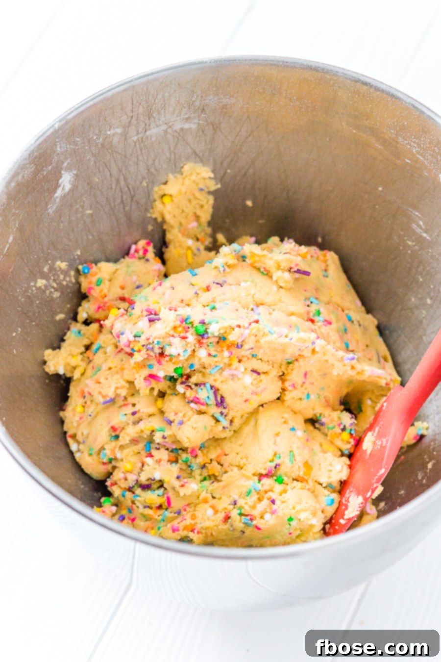 A tray of freshly baked Birthday Cake Pudding Cookies, warm from the oven, with sprinkles scattered on top.