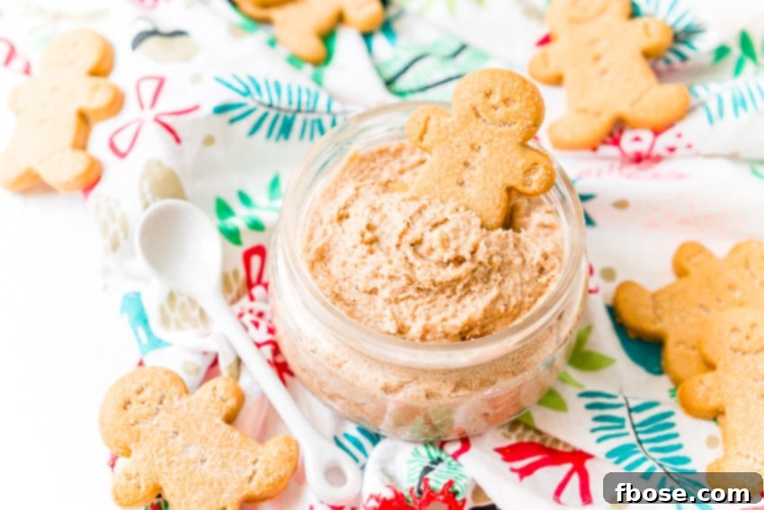 Decadent Gingerbread Skin Polish 5 A hand scooping whipped gingerbread sugar scrub from a glass jar, demonstrating its fluffy texture.