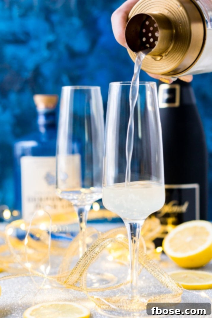 A close-up of a sparkling French 75 cocktail in a flute glass, highlighting its golden hue and the delicate bubbles.
