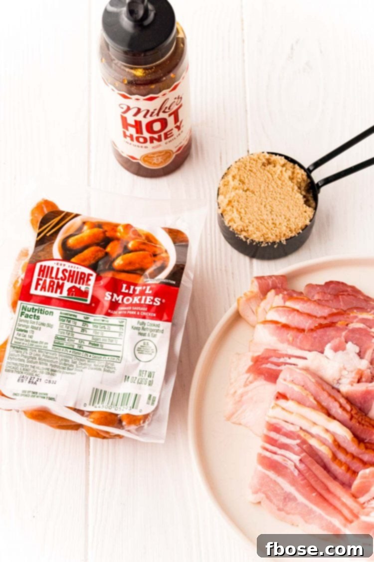 Ingredients to make bacon wrapped little smokies on a white table.