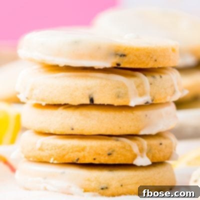 Stack of five Earl Grey Shortbread Cookies with pink background.