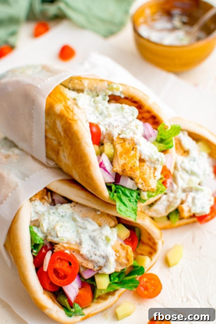 Close up photo of chicken gyros stacked on top of eachother.