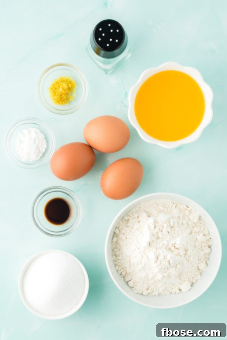 Overhead photo of ingredients prepped to make French madeleines, including eggs, flour, butter, and lemon.