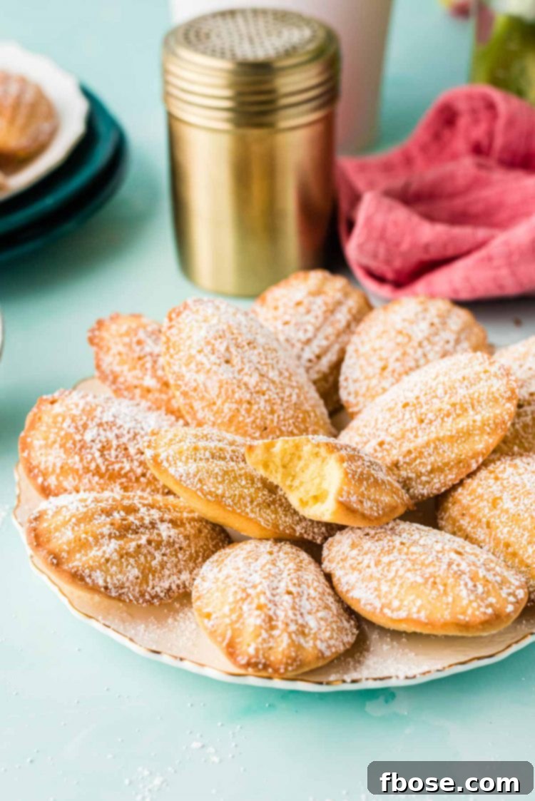 A plate of Madeleines on a blue counter, showcasing their elegant presentation.