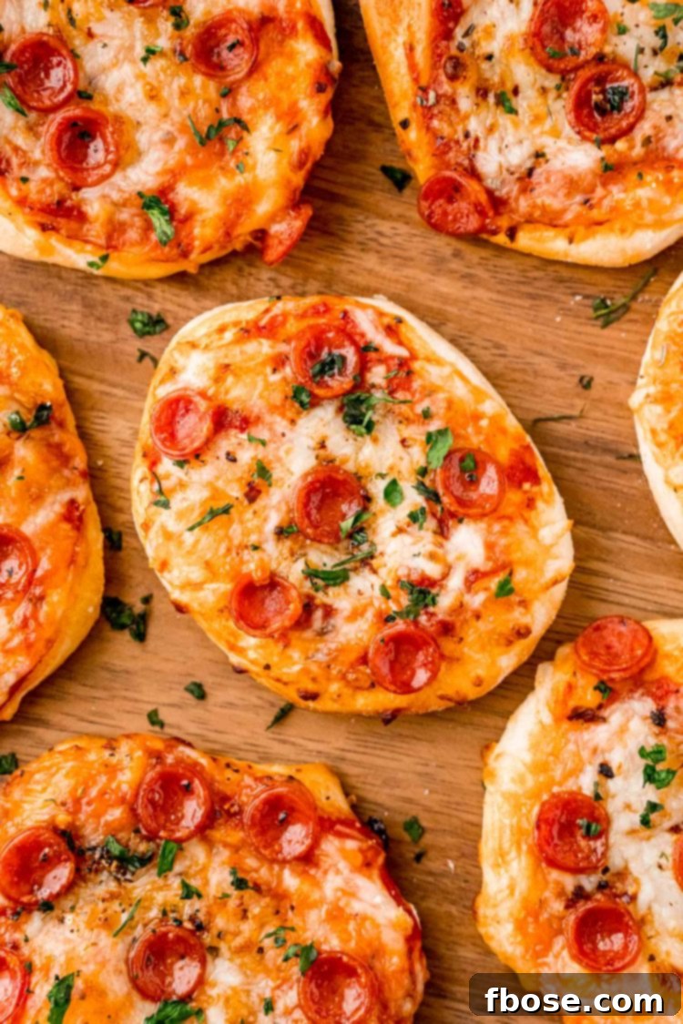 Close up photo of mini pizza on wood plate.
