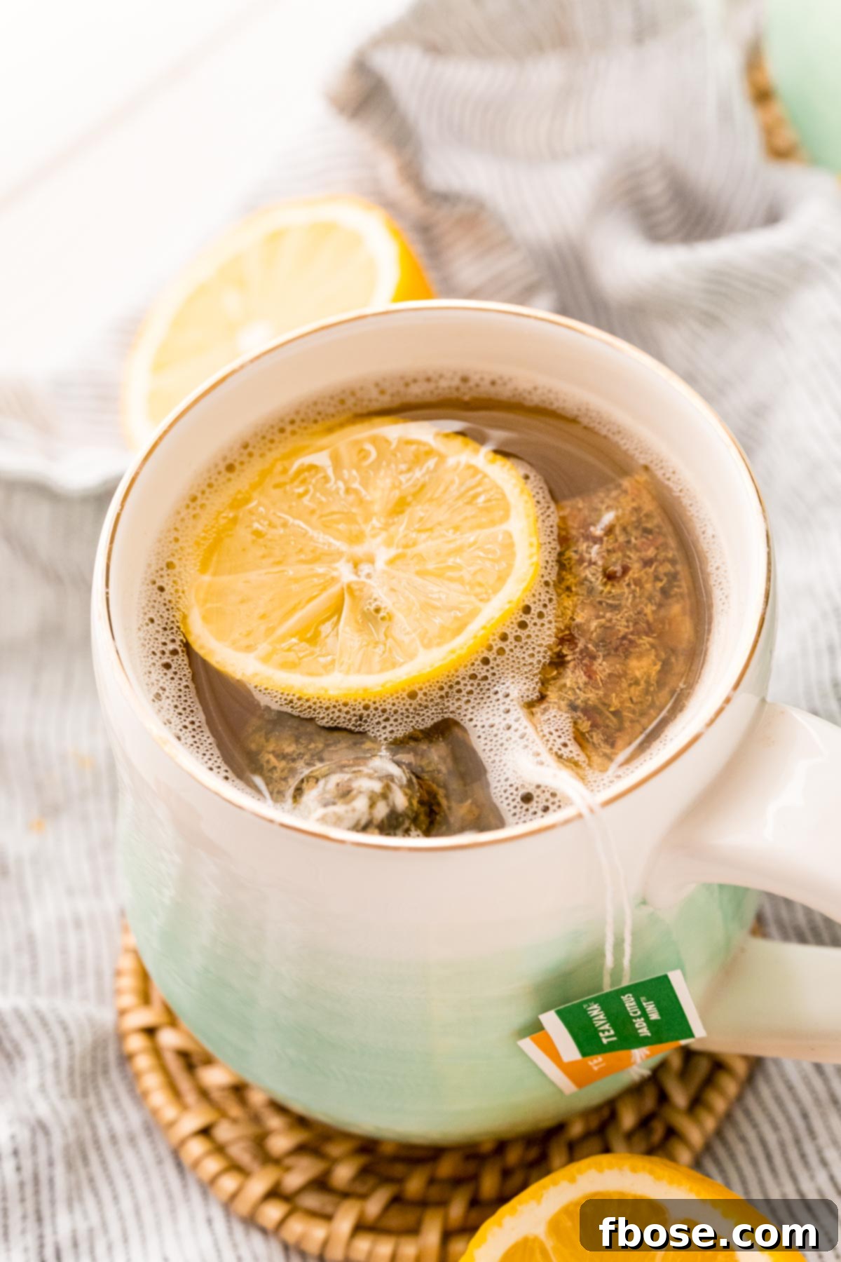 Close up photo of a mug with tea and lemonade in it, showing steam rising from the soothing Starbucks Medicine Ball Tea.