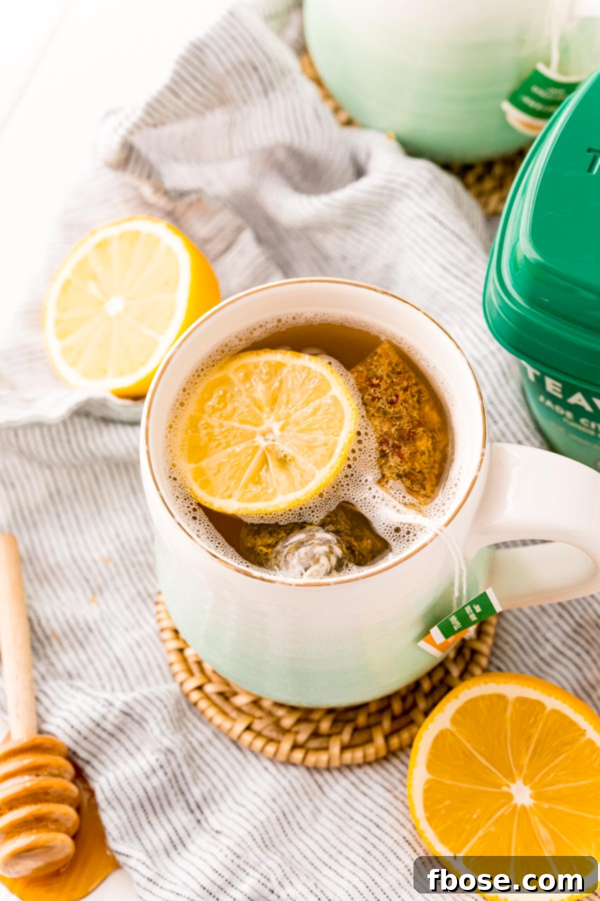 Starbucks medicine ball tea in a white and teal ombre mug on a wooden surface, ready to be enjoyed.