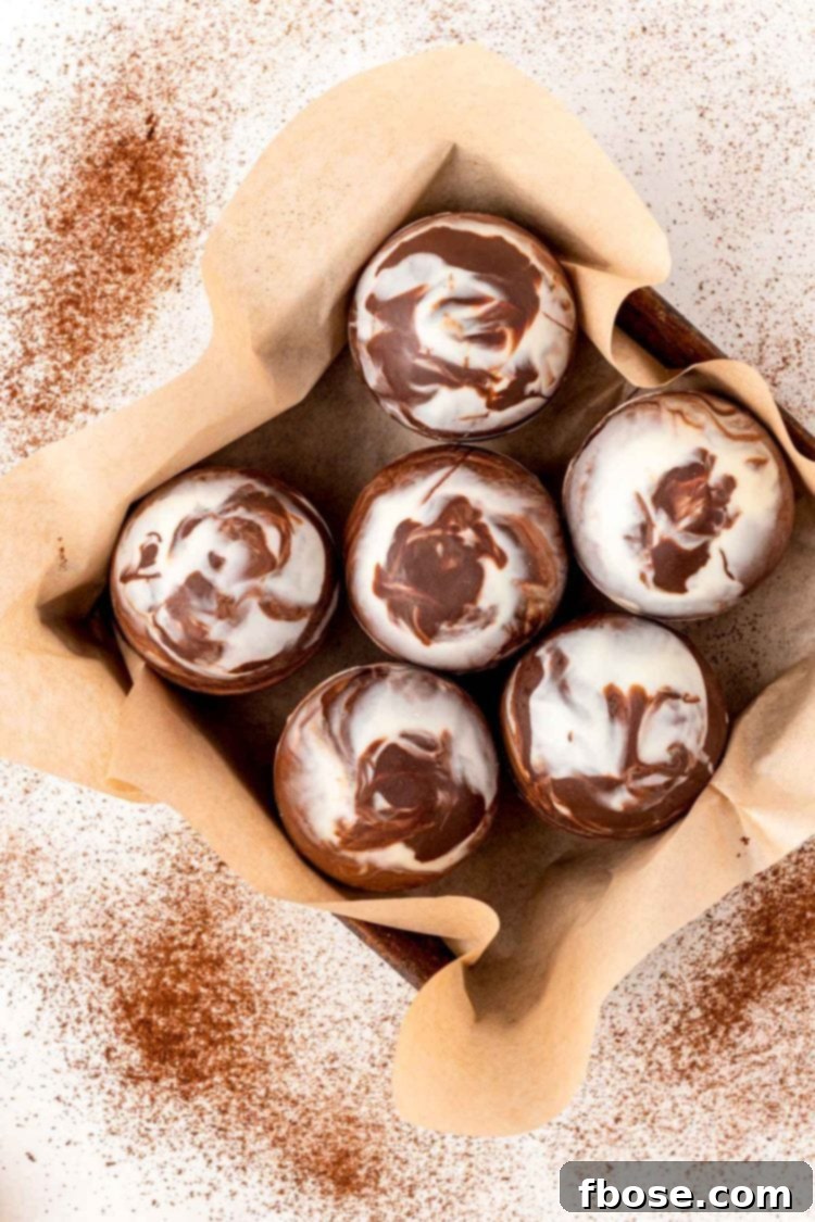 Overhead photo of mocha hot chocolate bombs in a pan with parchment paper.