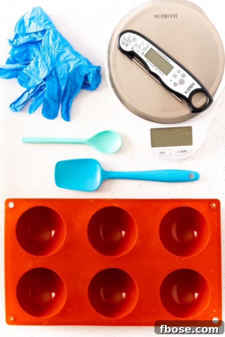 Overhead photo of tools to make hot chocolate bombs on a white table.