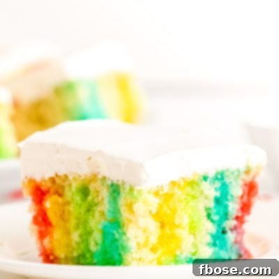 This Rainbow Jello Poke Cake is easily made using a boxed white cake mix and jello to create a fun, light dessert filled with vibrant colors!