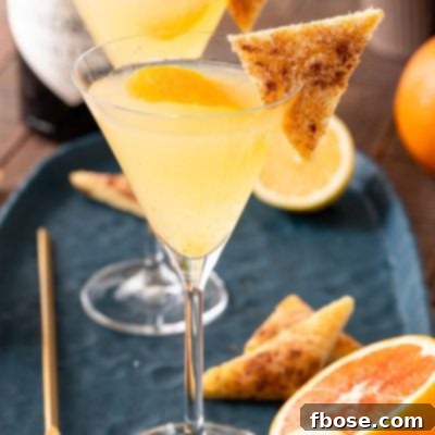 Breakfast Martini Simple Brunch Sipper 7 A close up photo of a breakfast martini garnished with cinnamon toast on a blue plate.
