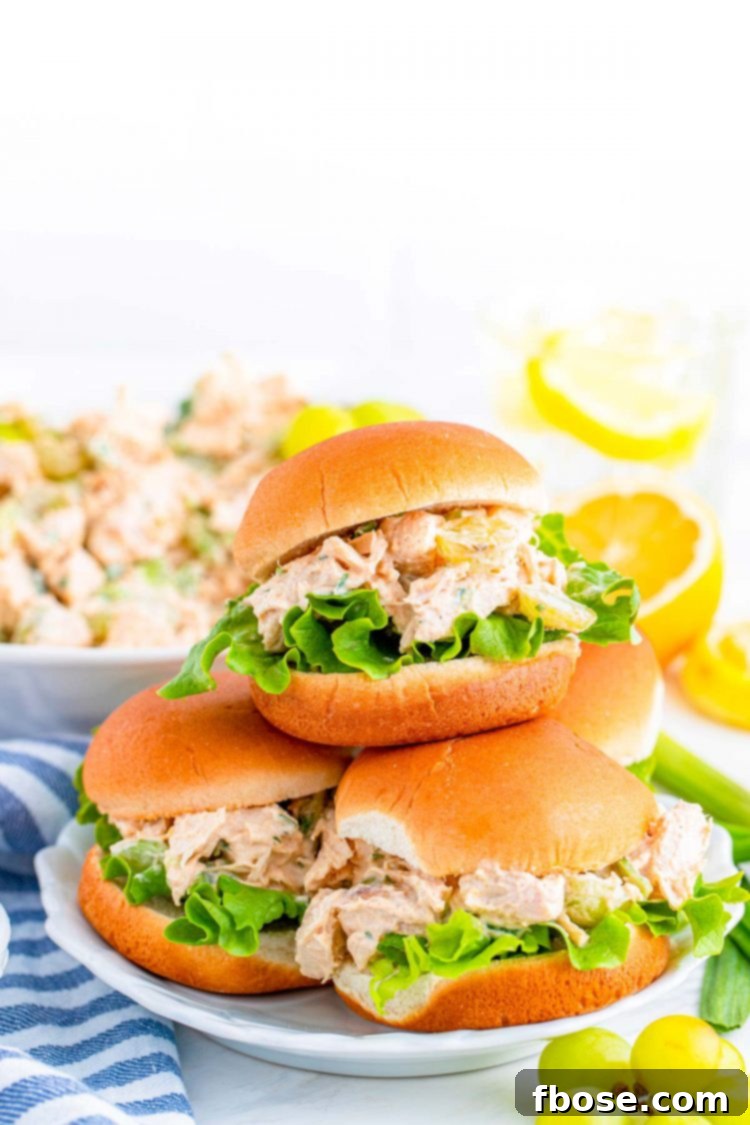 Orchard Chicken Salad 6 A plate with four chicken salad sandwiches stacked on it.