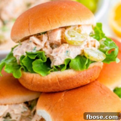 Close up photo of burger burns with chicken salad piled on a plate.