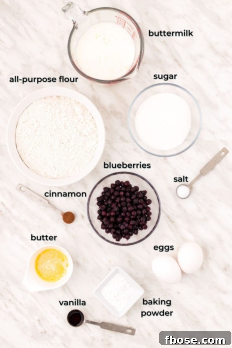 Ingredients to make blueberry donuts on a marble table.