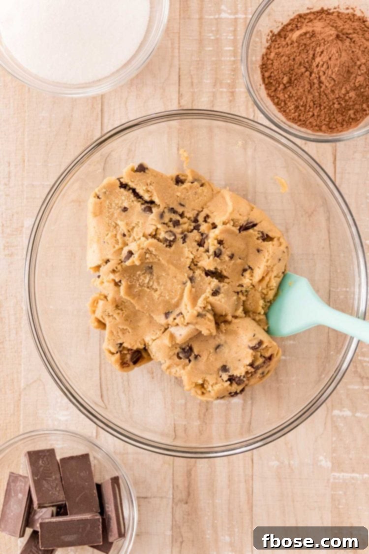 Overhead photo of ingredients to make mint chocolate chip cookies on a wooden table.