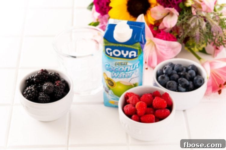 Ingredients for Nature's Cereal, including fresh berries and coconut water, arranged on a white table with flowers.