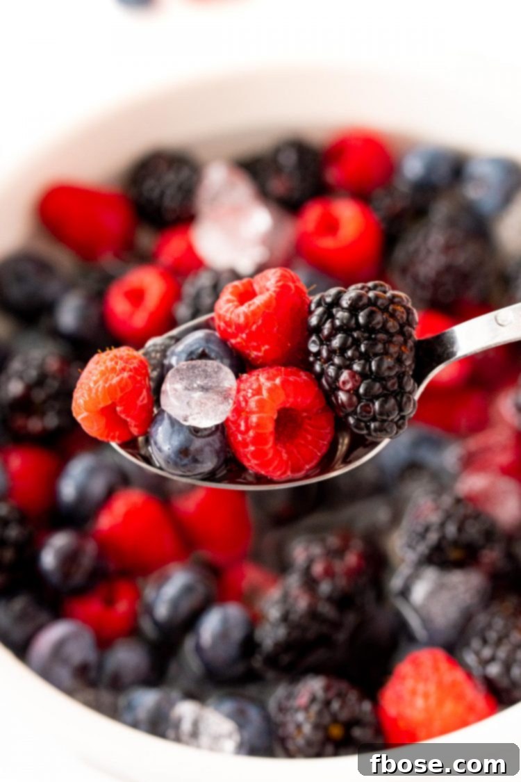 Close up photo of a spoonful of Nature's Cereal, showcasing the vibrant berries and coconut water.